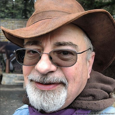 Photo of AlaskaJohn in cowboy hat and scarf